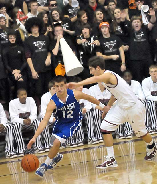 Bryant's Brantley Cozart tries to drive around Benton's Tyler Gattiin, a former Hornet, in Friday's game. (Photo by Kevin Nagle)