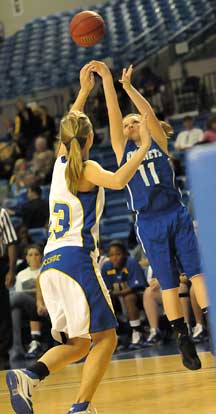 Logan Davis (11) launches a shot over Charlene Ellis (13). (Photo by Kevin Nagle)