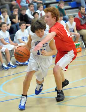 Bryant Blue's Gunnar Burks (15) drives around a Cabot North defender. (Photo by Kevin Nagle)