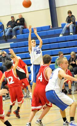 Mark Winn (30) fires a jumper as teammate Dylan Wolf (2) gets in position for a rebound. (Photo by Kevin Nagle)