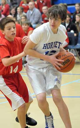 Jacob Pipken (12) looks for room to drive or pass. (Photo by Kevin Nagle)