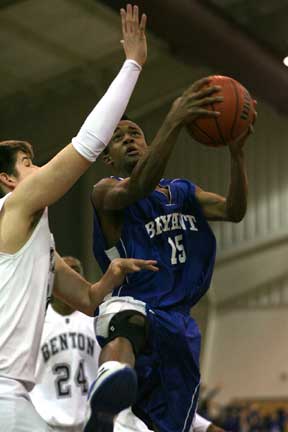 Aaron Bell, 15, tries to get around Benton's Zach Stuckey on his way to 2 of his game-high 10 points. (Photo by Rick Nation)