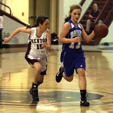Bryant's McKenzie Rice, 12, brings the ball into the front court ahead of Benton's Drew Melton. (Photo by Rick Nation)