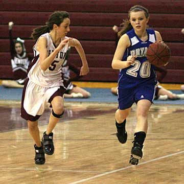 Bryant's Logan Davis, right, works the ball upcourt against Benton's Drew Melton. (Photo by Rick Nation)