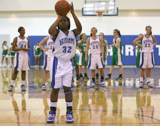 Bryant's Shanika Johnson shoots free throws while the rest of the players in Saturday's game wait at midcourt following a technical foul. (Photo by Rick Nation)