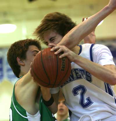 Bryant's Brandon Parish (2) is thwarted on a drive to the basket by the long arm of Van Buren's Hooper Vint. (photo by Rick Nation)