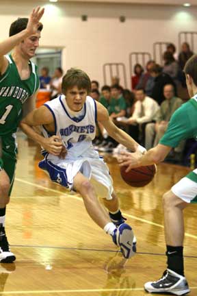 Bryant's Connor Rayburn tries to drive between a pair of Van Buren defenders including Jessie Schoolcraft (1). (Photo by Rick Nation)