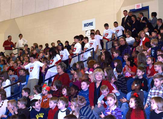 Students of Jami Branch's 3rd grade class decend the stairs in the gym floor where they were honored as the founders of the Arkansas History Room.  Following the students are Governor Mike Beebe and State Senator Shane Broadway.