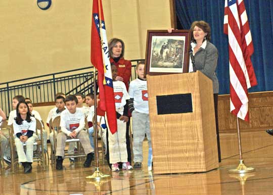 A representative of the office of Secretary of State, Charlie Daniels presents a copy of the "Arkansas Traveler" to be placed in the Arkansas History Room.