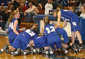 The Lady Hornets team celebrates after their 42-35 win. (Photo by Rick Nation)