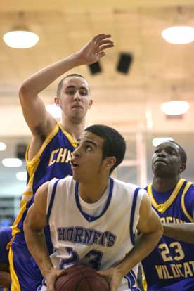 K.J. Hampton looks for room to get a shot off in front of North Little Rock's Mike Evans, left, and Chris Campbell (23). (Photo by Rick Nation)