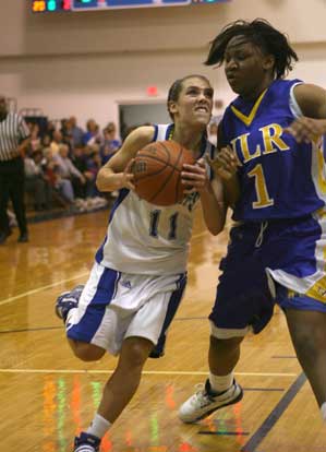 Haley Montgomery looks to score on a drive past North Little Rock's Cassie Vaughn. (Photo by Rick Nation)