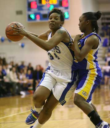 Alana Morris drives around North Little Rock's Kayla Brown. (Photo by Rick Nation)