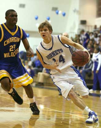 Bryant's Connor Rayburn drives around North Little Rock's Chris Campbell. (Photo by Rick Nation)