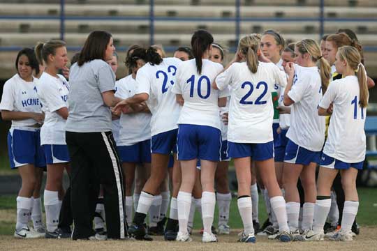 The Bryant Lady Hornets huddle to listen to head coach Julie Long during a break in Tuesday's action. (Photo by Rick Nation)