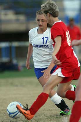 Tarra Hendricks (17) contends for a loose ball. (Photo by Rick Nation)