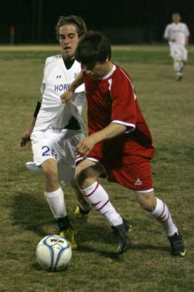 Bryant's Brandon Parish, left, battles with a Cabot player for control of the ball. (PHoto by Rick Nation)