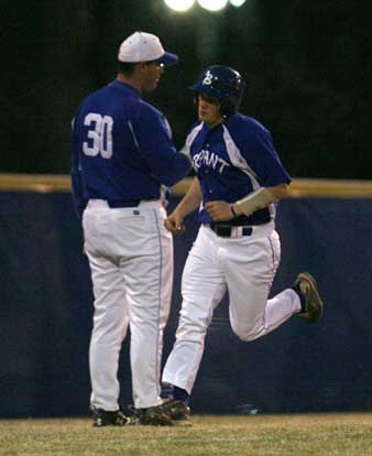 Brady Butler rounds third past coach Frank Fisher after his sixth-inning home run. (Photo by Rick Nation)