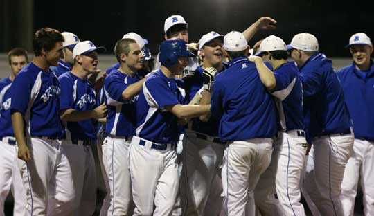 Bryant senior Brady Butler is surrounded by his teammates as they greet him following his game-ending home run Monday night. (Photo by Rick Nation)