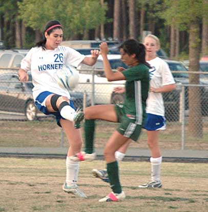 London Abernathy (26) tries to out-kick an opponent in a game from earlier this season. (Photo by Mark Hart)