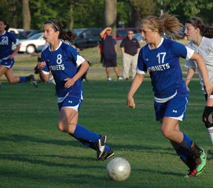 Shelby Gartrell (8) and Tarra Hendricks (17) advanced the ball in a match earlier this season. (Photo by Mark Hart)