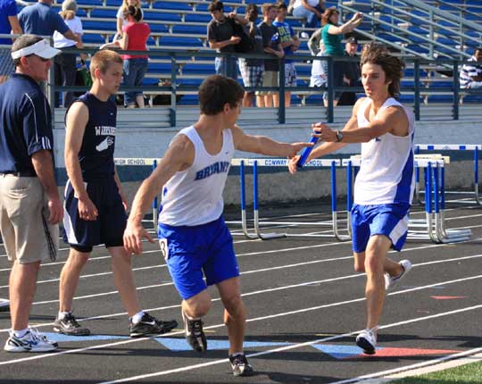 Keith McDonald hands off to Michael Smith during the 4x800 meter relay. (Photo courtesy of Carla Thomas)