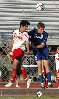 Bryant's Kyle Nossaman, right, goes head-to-head with a Russellvile player. (Photo by Mark Hart)