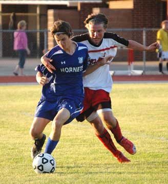 Bryant's Sean Sobba, left, tries to keep possession despite being grabbed. (Photo by Mark Hart) 