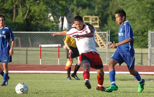 Bryant's Jose Vazquez, right, battles with a Russellville player for control of the ball. (Photo by Mark Hart)