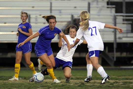 Bryant's Erica Selig tries to thwart the progress of a North Little Rock player during Monday's game. (Photo by Misty Platt)