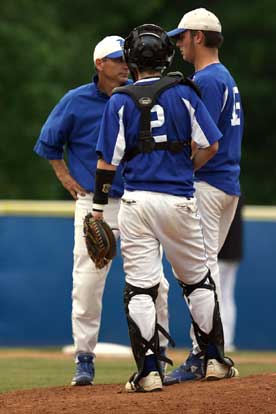 Bryant head coach Kirk Bock meets with pitcher Ben Wells and catcher B.J. Ellis during Monday's game. (Photo by Rick Nation)