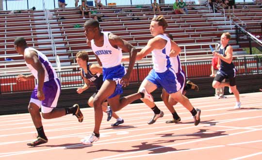 Tanner Tolbert hands off to Kendrick Farr in the 400 meter relay prelims. (Photo by Carla Thomas)