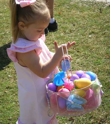 Makayla Vendez adds another Easter egg to her collection. (Photo by Diane Winiecki)