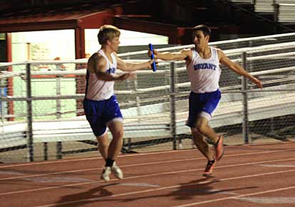 Dylan Blasi hands the baton to Tyler Freshour during 1600 meter relay at Cabot Tuesday. (Photo by Carla Thomas)