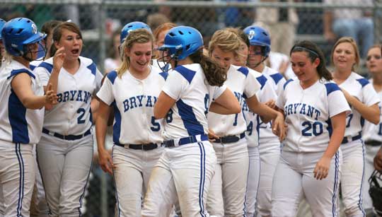 Jessie Taylor is greeted by her teammates after her three-run homer Tuesday night. (Photo by Rick Nation)