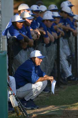 Head coach Kirk Bock and the players in the Bryant dugout look intently on the action Monday night. (Photo by Rick Nation)