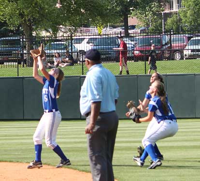 Bryant second baseman Jenna Bruick settles under a pop fly as teammates Kelsie Works and Hannah Rice charge in from the outfield, just in case. (Photo courtesy of Phil Pickett)