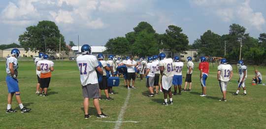 Head coach Paul Calley works with the offensive line. 
