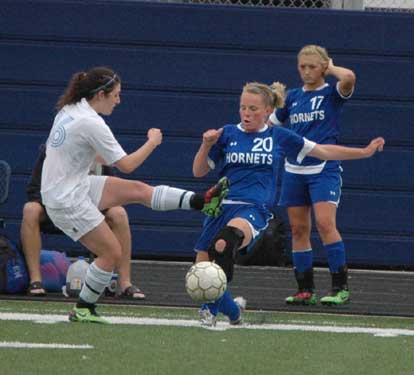 Lauren Reed (20) tangles with a Southside player as Tarra Hendricks looks on from the sideline. (Photo by Mark Hart)