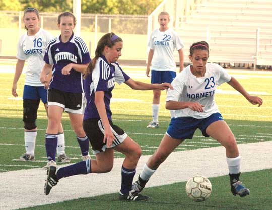 McKenzie Adams (23), Erica Selig (16) and Lindsey Brazil (22) (PHoto by Mark Hart)