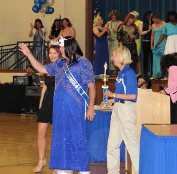 Sherry (Larry) White, owner of Larry's Pizza waves to admirers after winning one of the pageant categories.