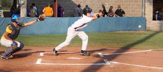 Trent Rivers gets a bunt down during the first game of Tuesday's doubleheader at Sheridan. (Photo by Phil Pickett)