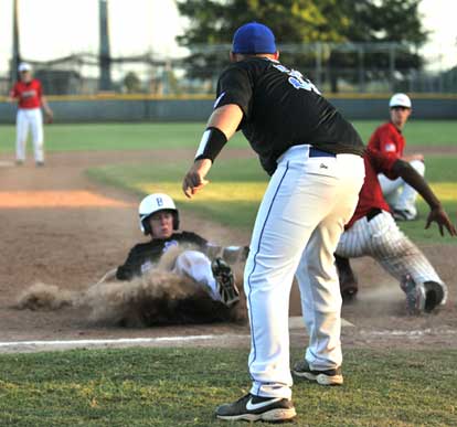 Tyler Nelson slides into third under direction from manager Jimmy Parker. (Photo by Ron Boyd)