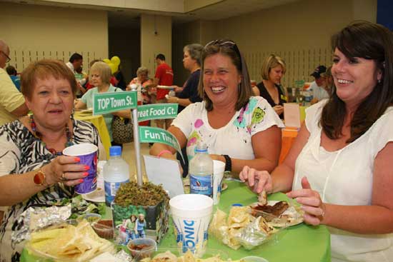 Jeanne Benz, Jennifer Caton, and Neeli Kinzler enjoy a variety of food samples.