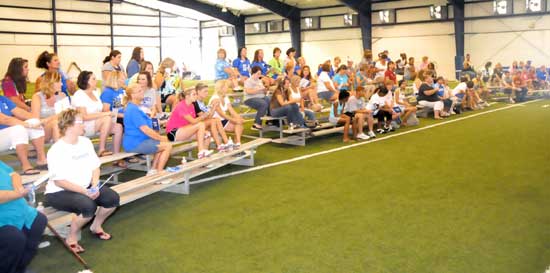 The Mommies in attendance at the annual Football for Mommies await instructions as the session begins. (Photo by Kevin Nagle)