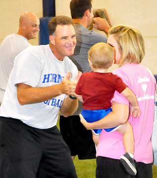Head coach Paul Calley greets a special guest to Football for Mommies. (Photo by Kevin Nagle)