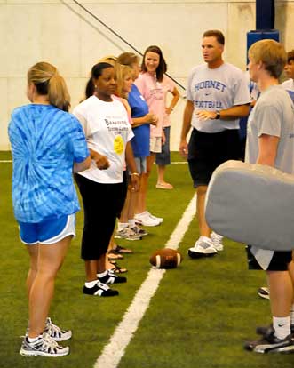 Head coach Paul Calley gives instructions to his offensive line Mommies. (Photo by Kevin Nagle)