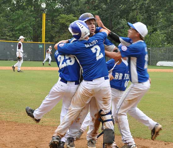 Wesley Akers is greeted by his teammates after his three-run double capped Bryant's nine-run seventh-inning rally. (Photo by Bradley Miller)