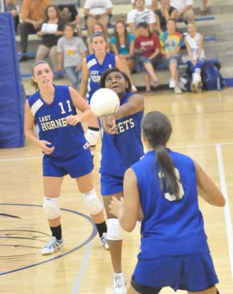 Dezarea Duckworth keeps a volley alive in front of teammates ERica Smith (11), Kayla Jolley (1) and Abree Allen (3). (Photo by Kevin Nagle)