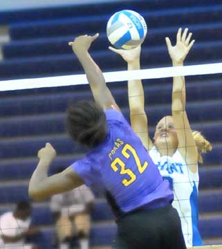 Maggie Hart goes up for a block. (Photo by Kevin Nagle)